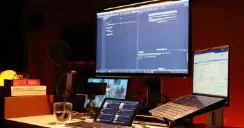 black flat screen computer monitor turned on beside black laptop computer